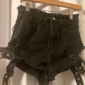 Black distressed denim shorts with buckles